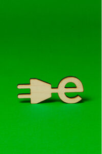 Wooden “e” symbol with a plug, representing electric mobility